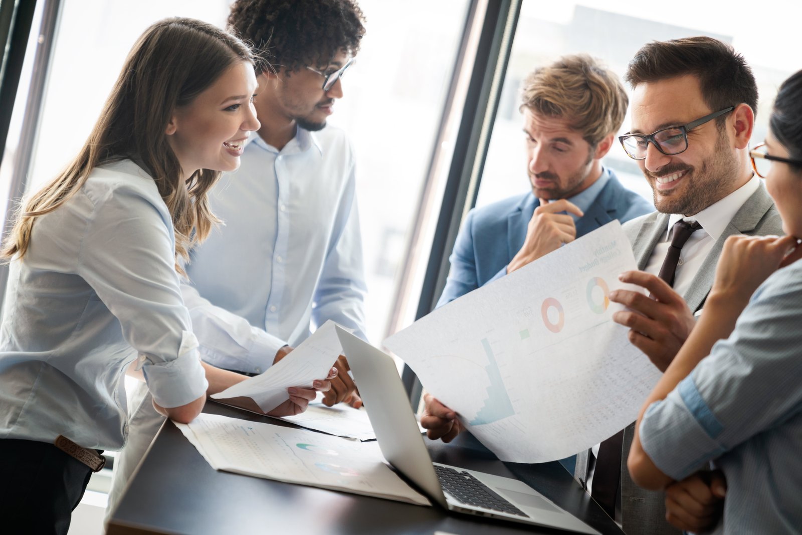 Image of business partners discussing documents and ideas